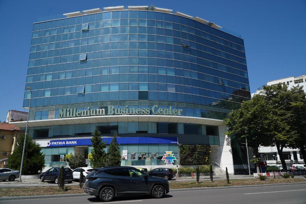 a car parked in front of a glass building at Millennium Hub & Hotel in Constanţa