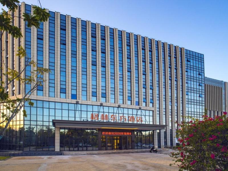 a large building with a sign on the front of it at GreenTree Eastern Hotel Hainan Free Trade Port Jiangdong New District Meilan Airport in Haikou
