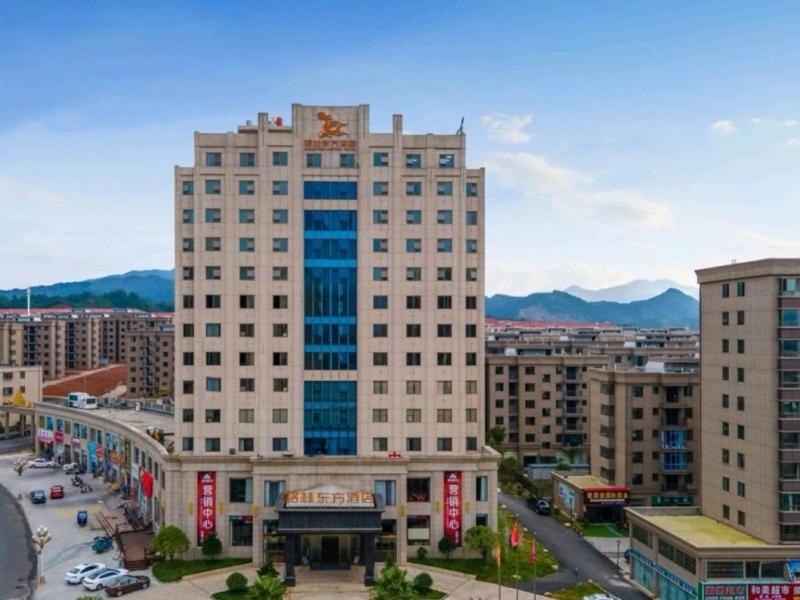 a tall building with a clock on top of it at GreenTree Eastern Hotel Ji'an City Suichuan Industrial Park in Suichuan