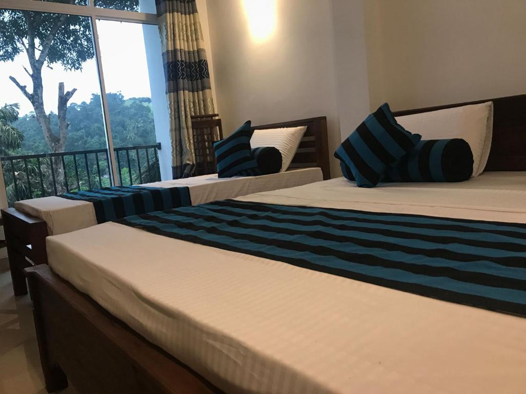 Katil atau katil-katil dalam bilik di Sarala Residence