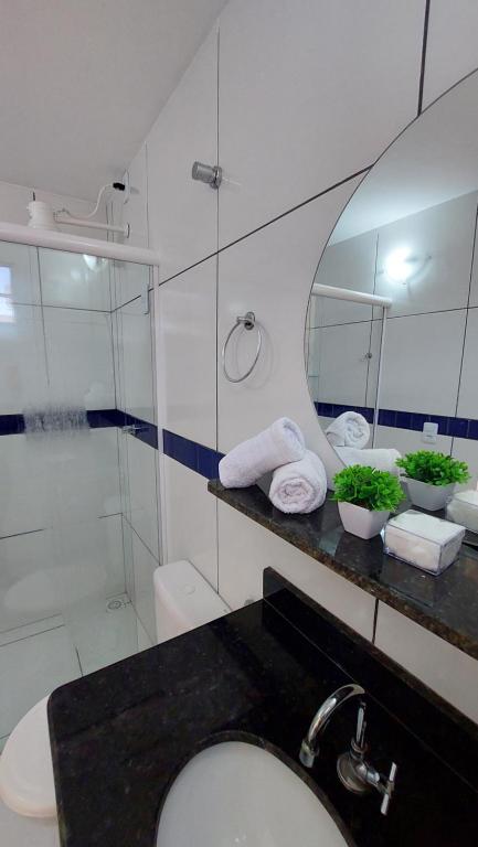 a bathroom with a sink and a shower and a mirror at JACY AP GOSTOSO in São Miguel do Gostoso
