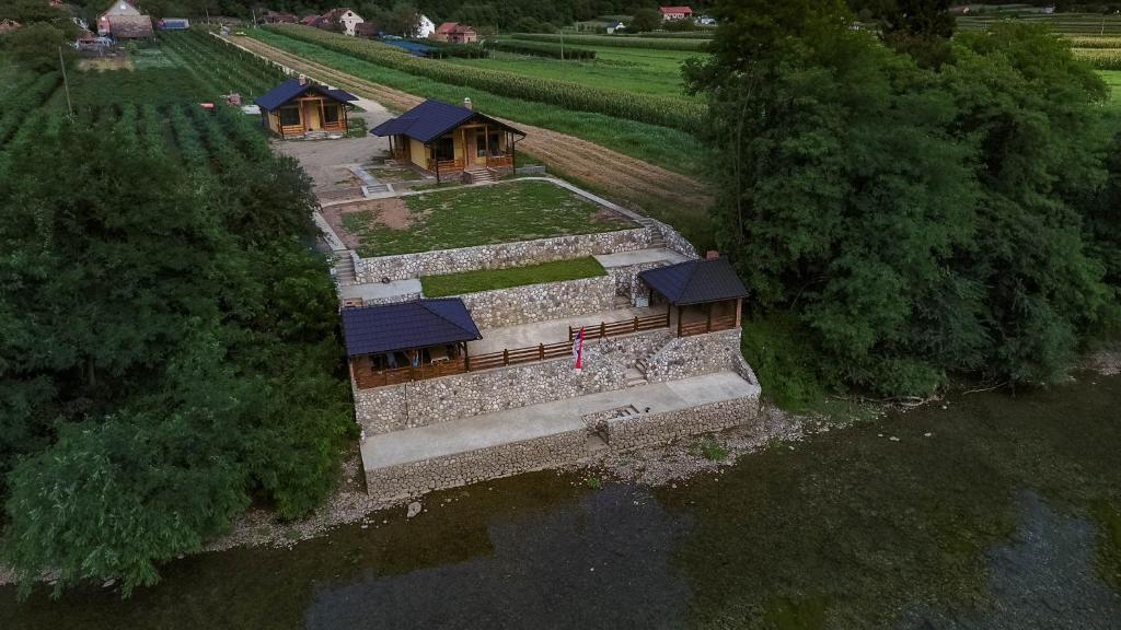 an aerial view of a house in the water at Apartmani Zavičaj Gornja Trešnjica in Ljubovija