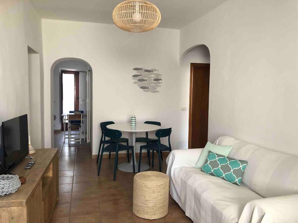 a living room with a couch and a table at CasaMare. Orbetello centro storico. in Orbetello