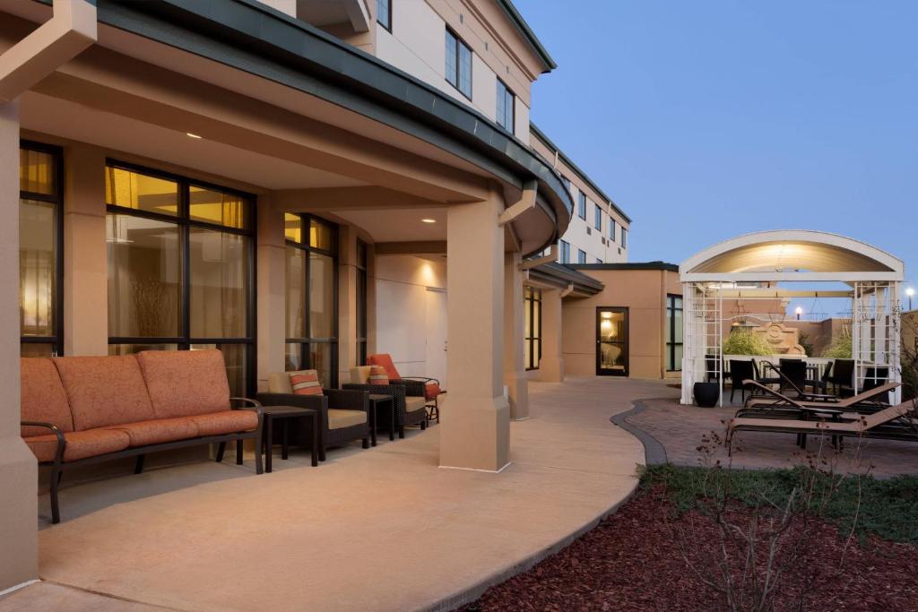 a patio with couches and tables on a building at Courtyard by Marriott Oklahoma City North/Quail Springs in The Village