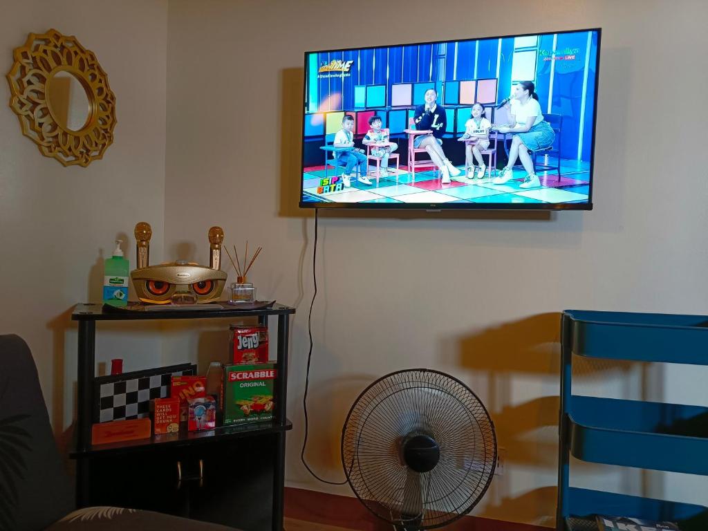 a flat screen tv hanging on a wall at ANNE'S RESIDENCES in Manila
