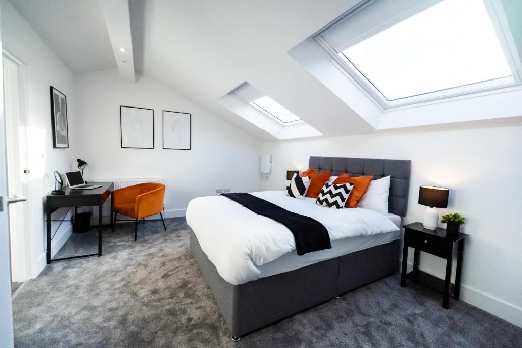 a bedroom with a bed and a desk in it at Hosta Group - Prestige 1 Bed Apartment - The Orange in Cambridge
