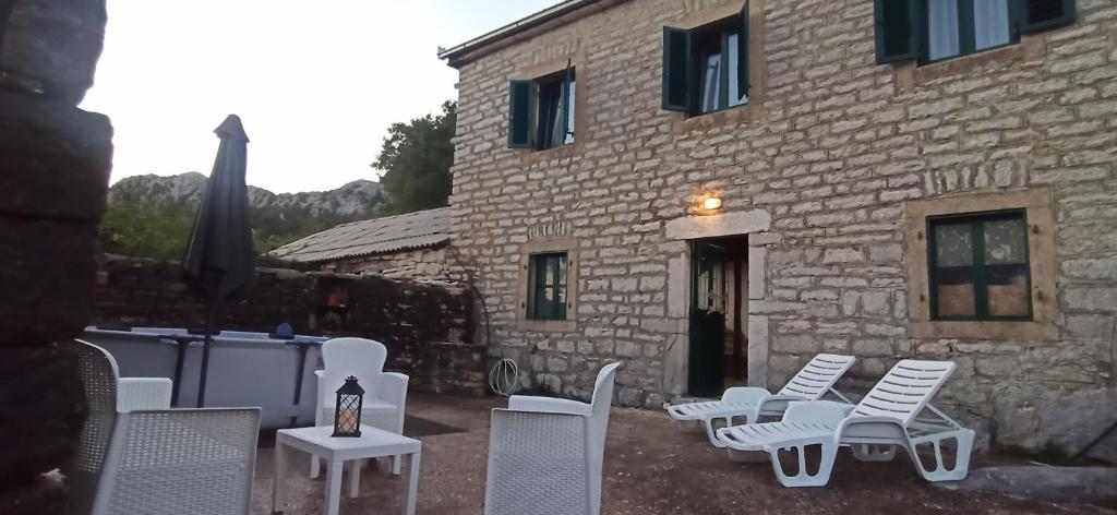 a group of chairs and tables in front of a building at Old house Djurovic in Herceg-Novi