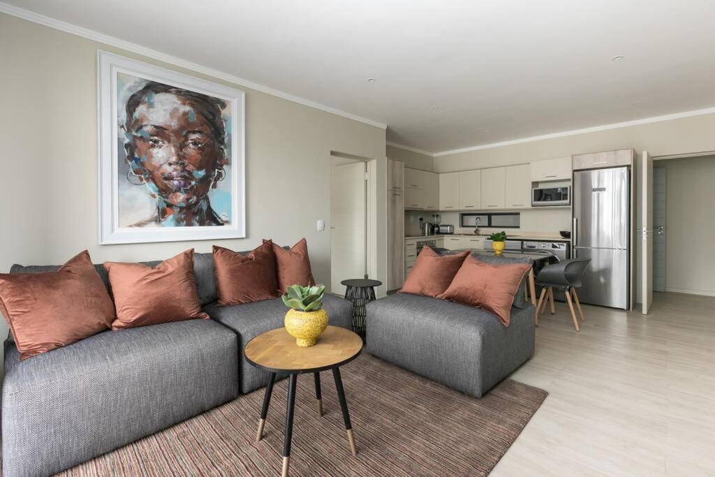 a living room with a couch and a table at Lux 2bed 20Mb WiFi on Keyes artmile 2km 2 Gautrain in Johannesburg