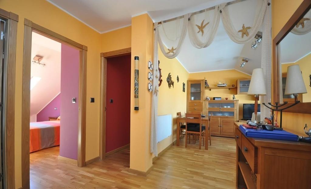 a room with a kitchen and a bedroom with a bed at Acogedor ático a pie de mar y montaña. in O Pindo