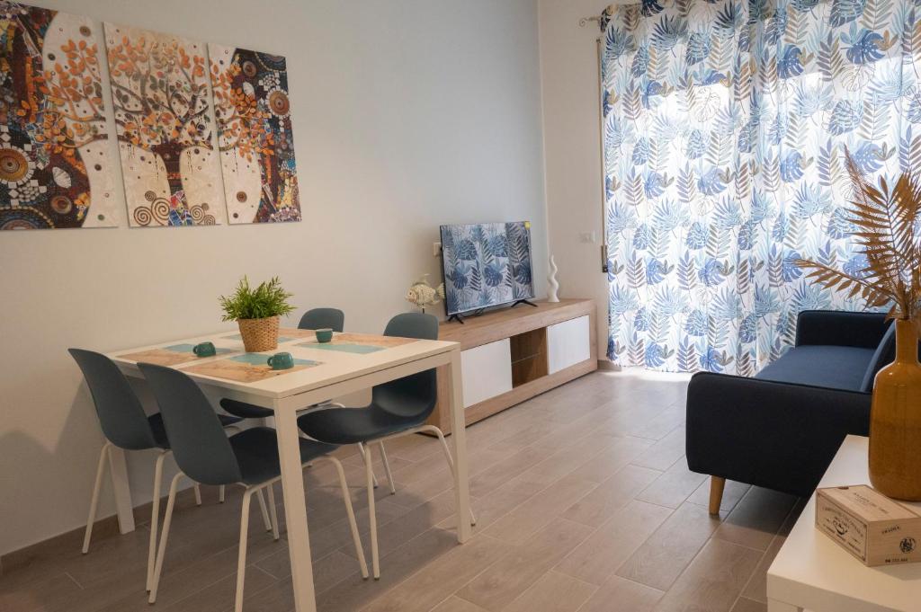 a living room with a dining room table and chairs at antica dogana apartments scirocco in Terracina