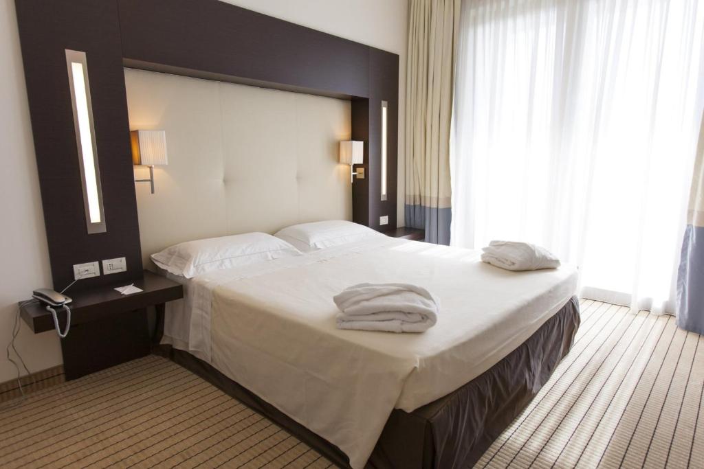 Łóżko lub łóżka w pokoju w obiekcie Hotel & Residence Villa Bartolomea