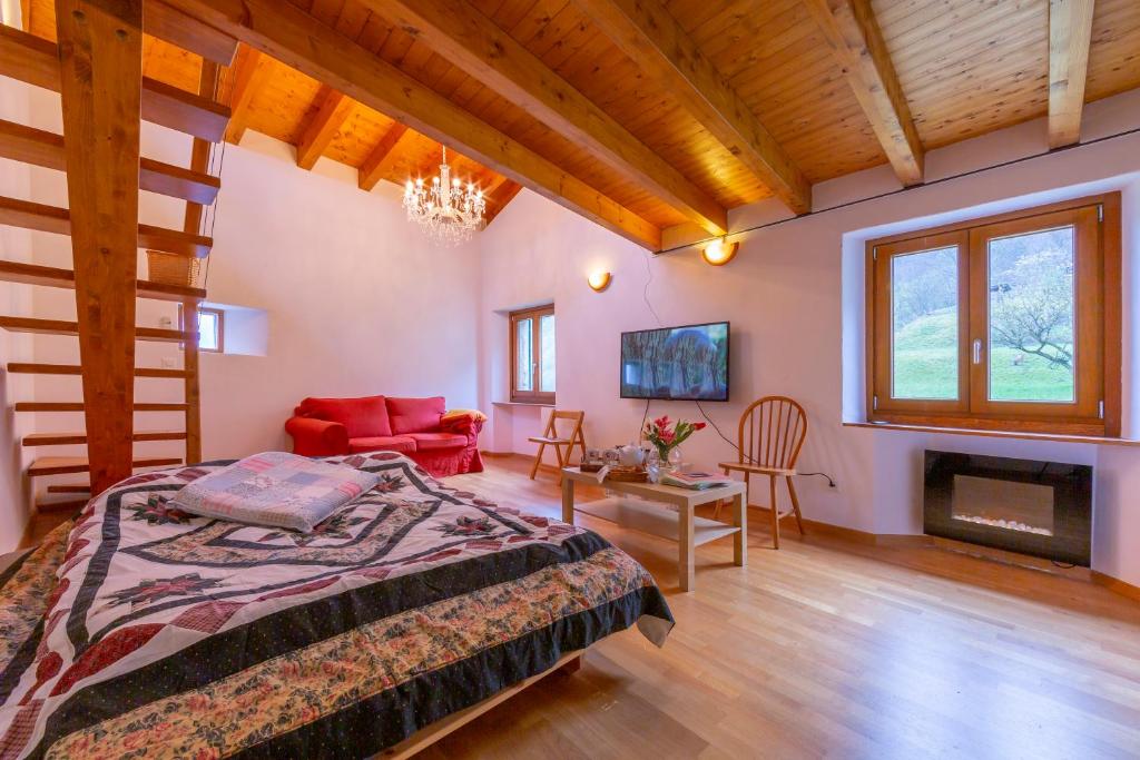 a bedroom with a bed and a fireplace at Casa Gialla - Happy Rentals in Pugerna