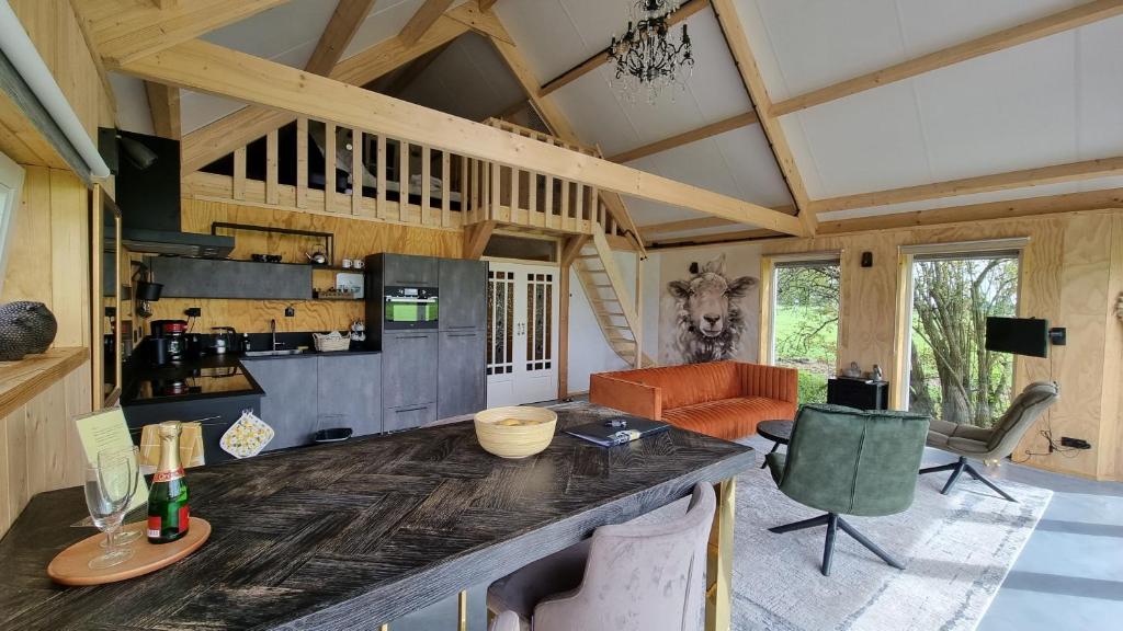 a kitchen and living room with a large counter top at City Farmers Lodge, a Guesthouse with a skyline view in Rural Amsterdam in Amsterdam