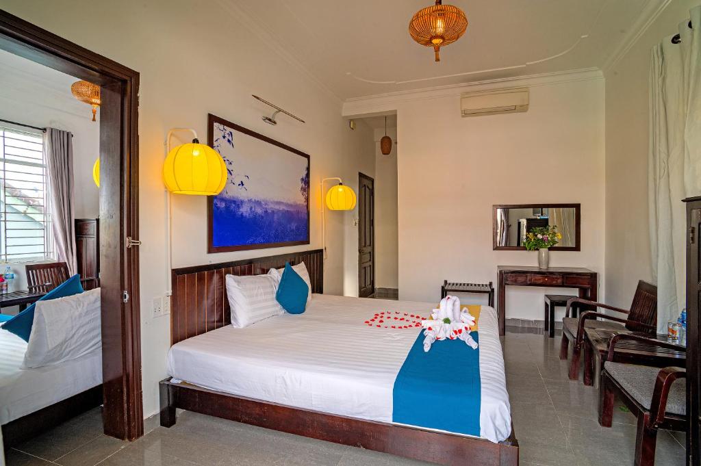 Postel nebo postele na pokoji v ubytování Hoi An Viet House Homestay