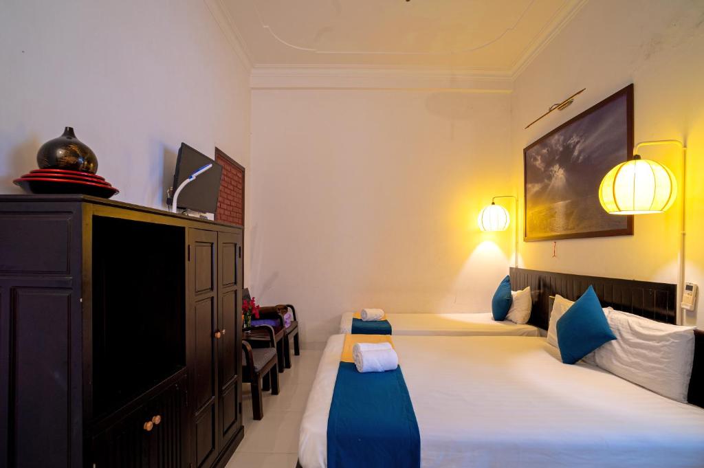 Postel nebo postele na pokoji v ubytování Hoi An Viet House Homestay