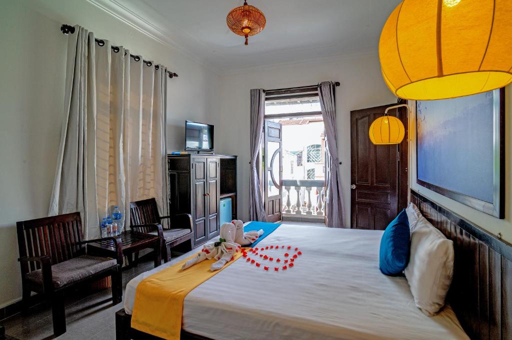 Postel nebo postele na pokoji v ubytování Hoi An Viet House Homestay