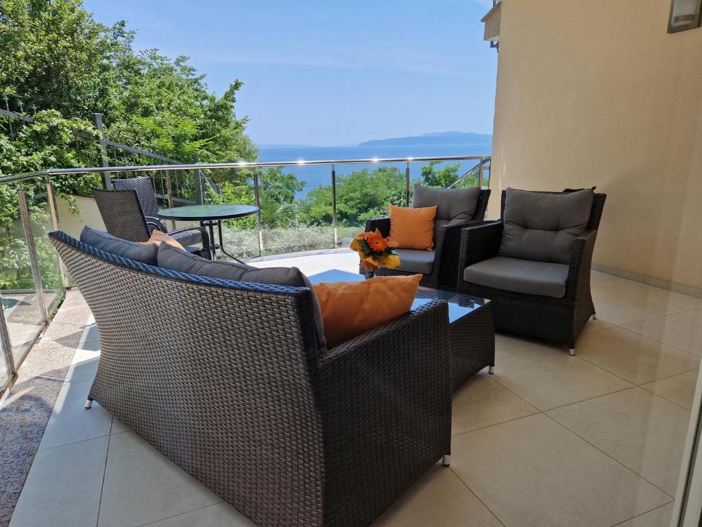 a patio with chairs and a table on a balcony at Magnolia in Opatija
