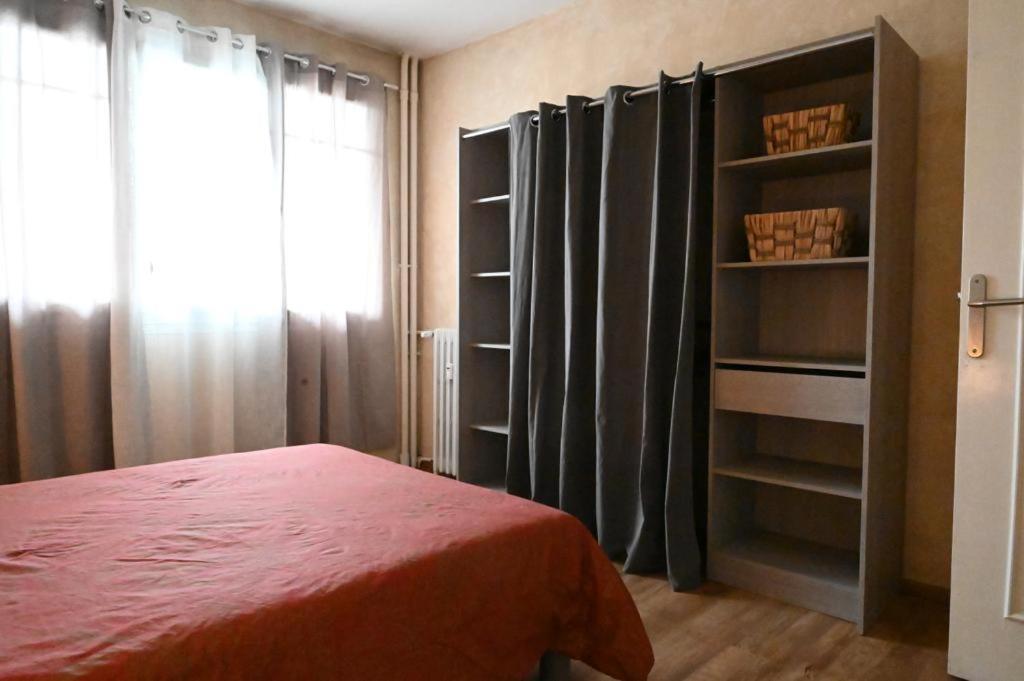 a bedroom with a bed and a book shelf at Grand appartement cosy-Hyper Centre-Place Verdun in Tarbes