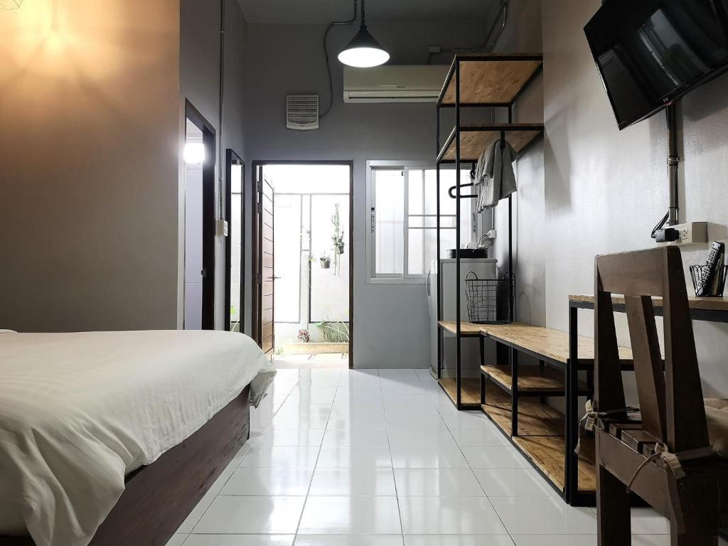 una camera con letto e scrivania di Siri Guesthouse @ Surat Thani a Suratthani