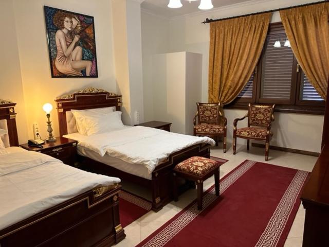 Postel nebo postele na pokoji v ubytování Dinasty Hotel