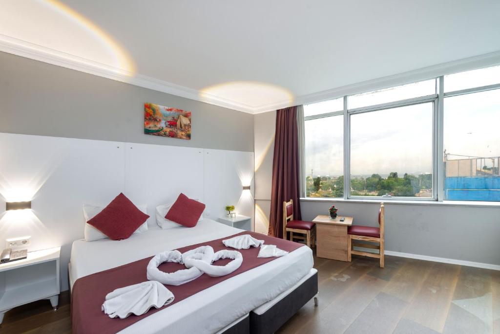 a hotel room with a large bed with towels on it at Grand Abimo Hotel in Istanbul