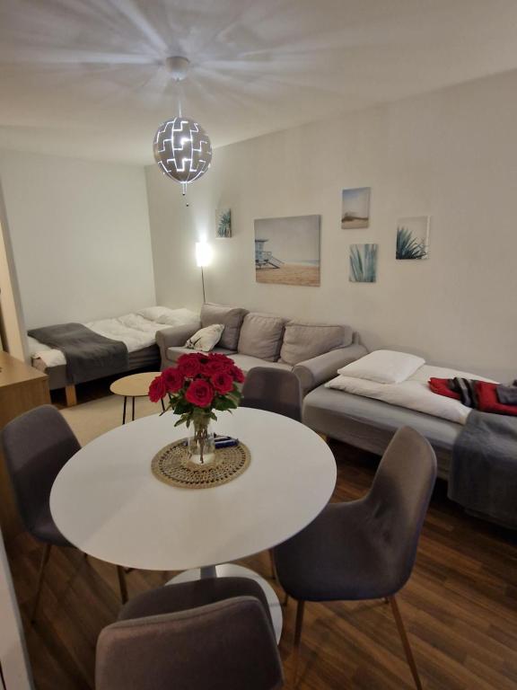 sala de estar con mesa y sofá en Lovely studio apartment, glazed balcony and own parking space, en Hyvinkää