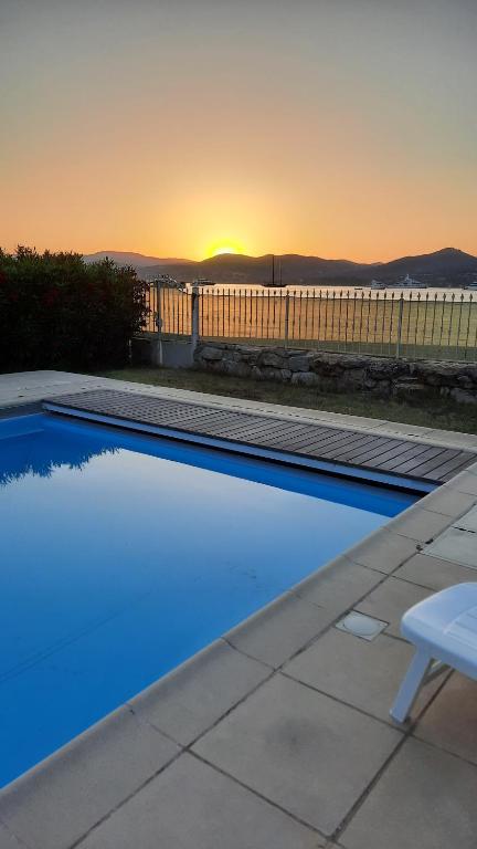 a swimming pool with a sunset in the background at Villa Playa del Sol -B4 in Saint-Tropez