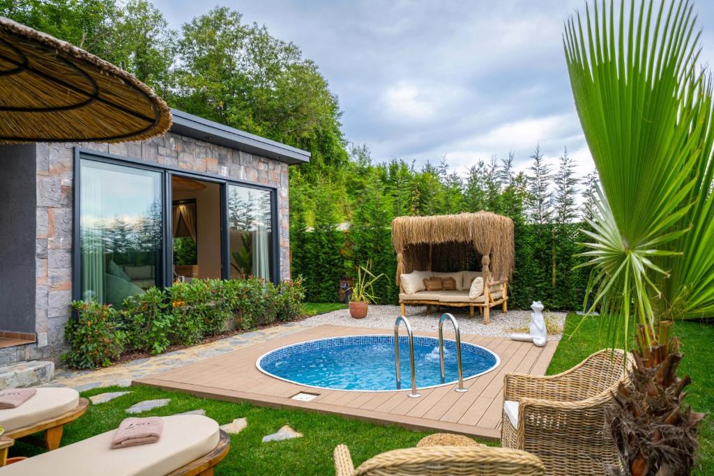 a backyard with a swimming pool and a patio with a chair at ON7 Sapanca Private in Sapanca