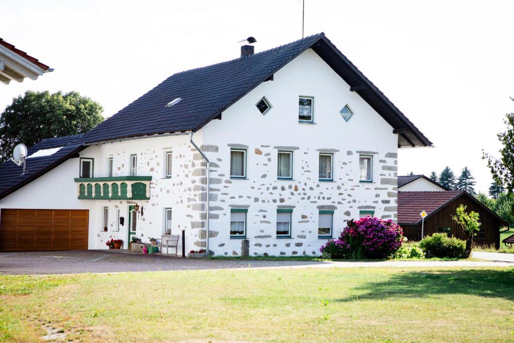 a large white house with a black roof at Ferienhaus Drasch in Lalling