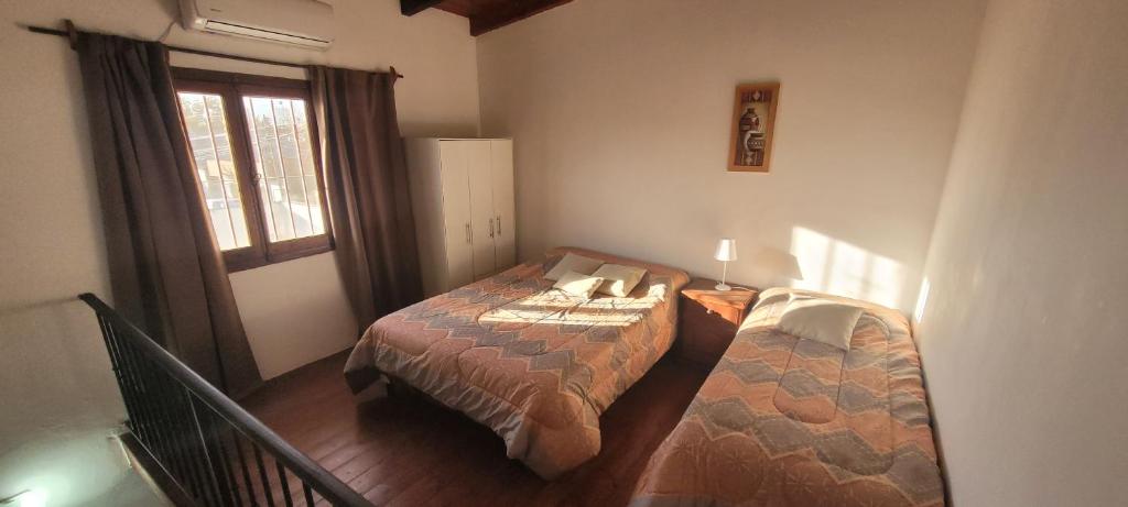 a bedroom with a bed and a window at Depto de La Lila in Salta