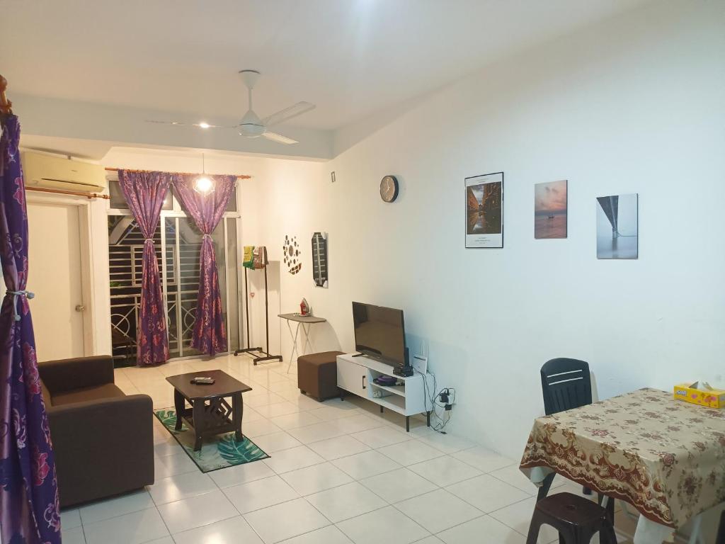 een woonkamer met een bed en een tv. bij 3rd floor apartment with 2 bedroom and no elevator in Kota Bharu