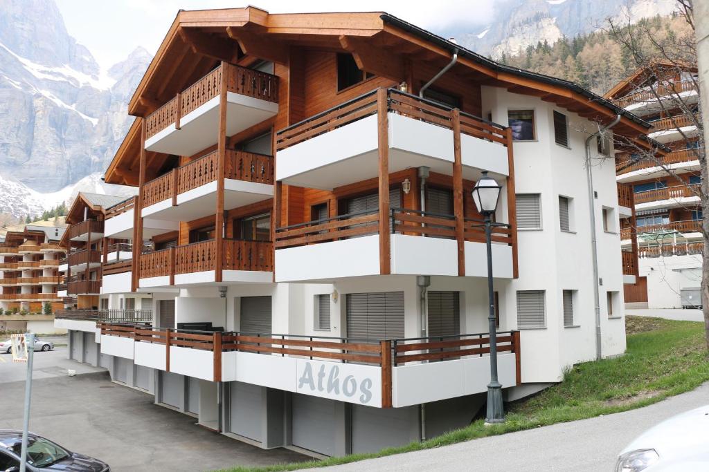 a large building with balconies on the side of it at Alpenblick Leukerbad in Leukerbad