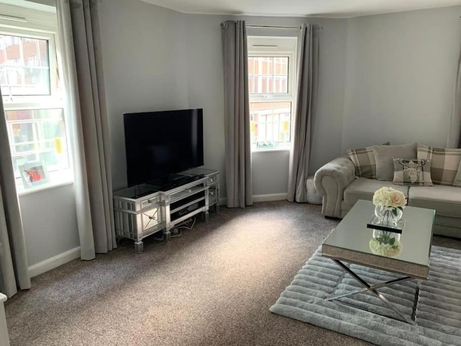 a living room with a couch and a tv at Apartment In Birmingham City Centre in Birmingham