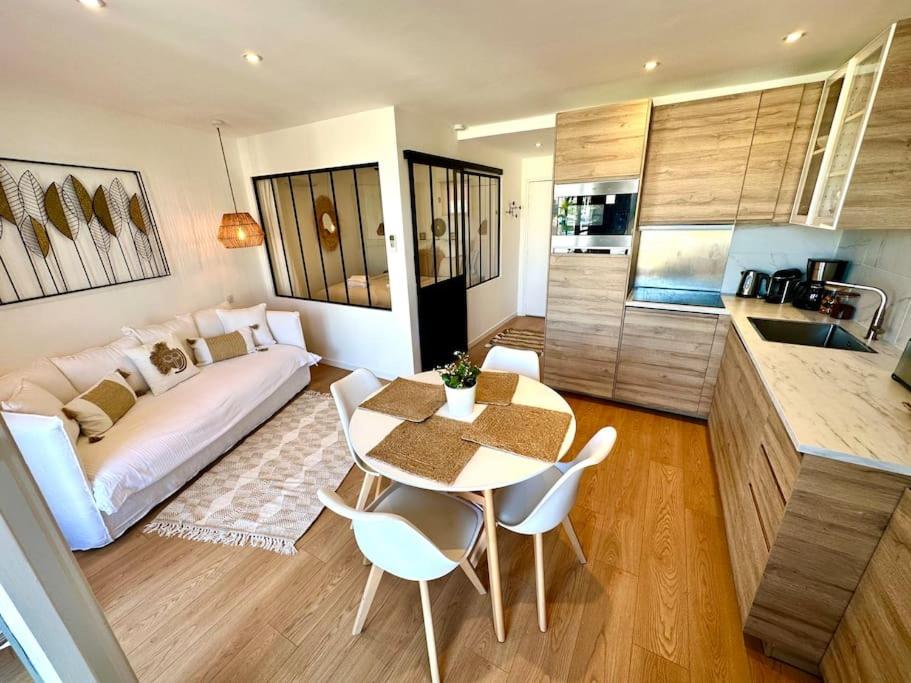 a living room with a bed and a table and chairs at Pura Vida, Port Grimaud in Grimaud