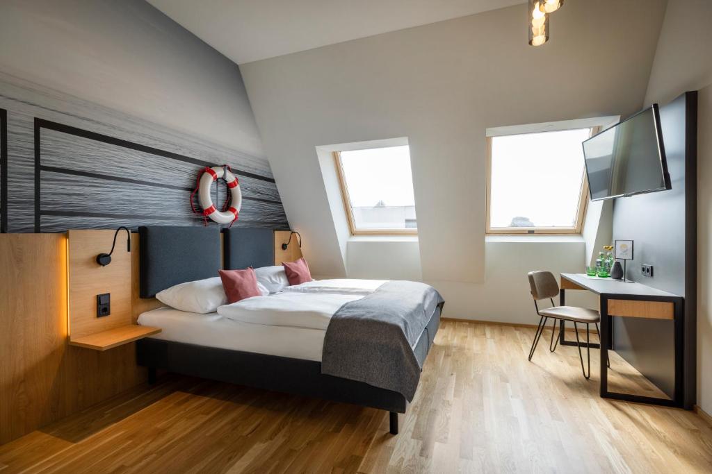 Postel nebo postele na pokoji v ubytování JUFA Hotel Bregenz