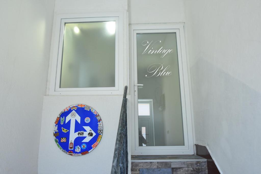 a door with a wreath on it next to a window at Vintage Blue in Kumanovo
