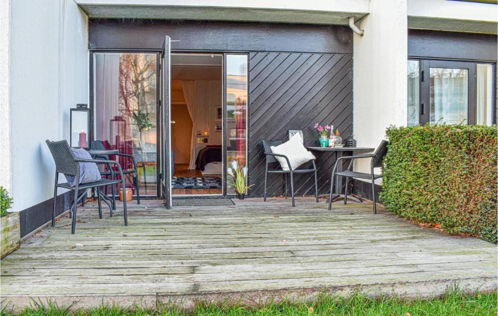 a deck with chairs and a table on a house at Amazing Apartment In Helsingr With Kitchen in Helsingør