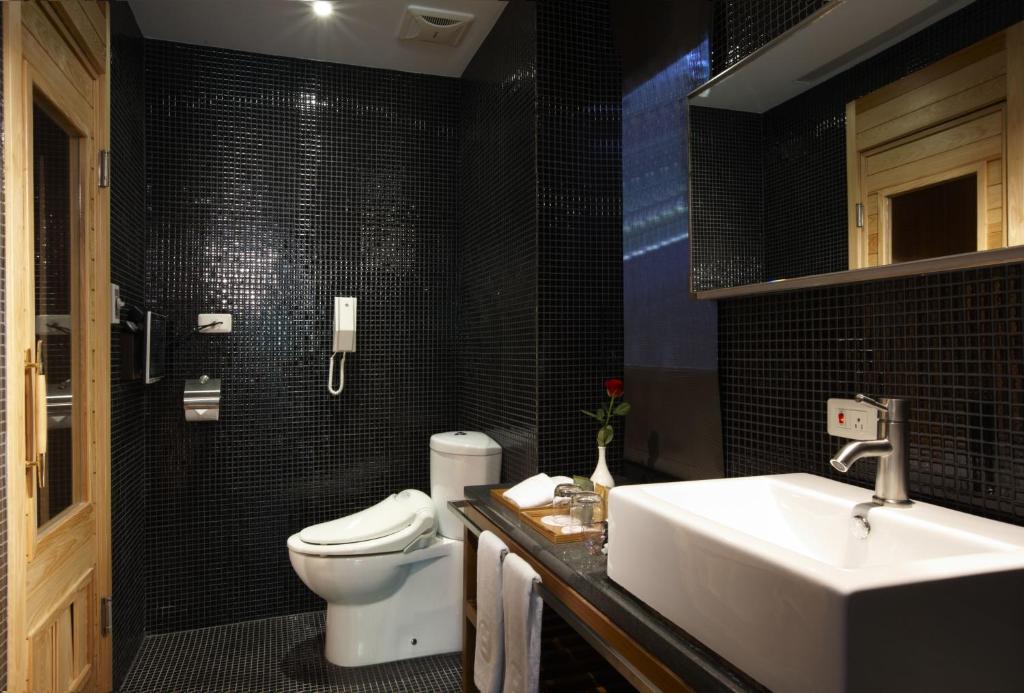 a bathroom with a white sink and a toilet at Hotel Double One in Taipei