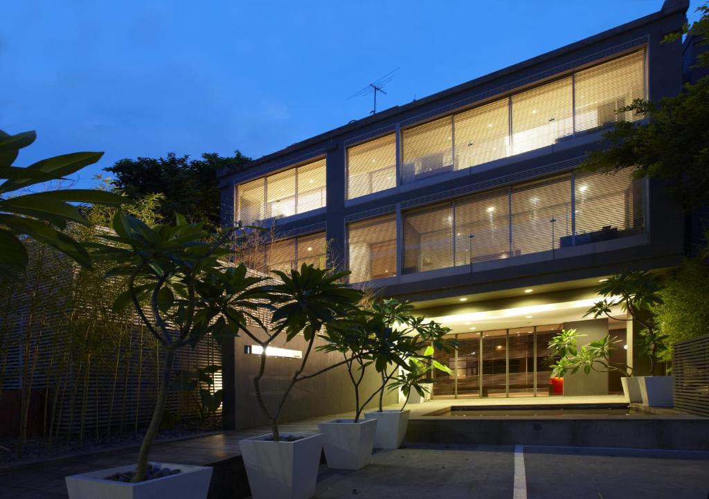 a large building with palm trees in front of it at Hotel Double One in Taipei