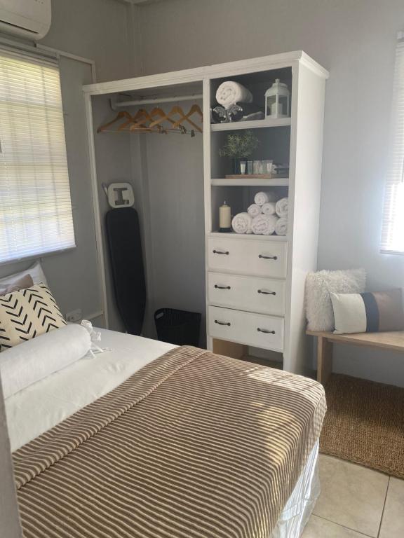 a bedroom with a bed and a dresser at Keikei’sHaven in Gros Islet