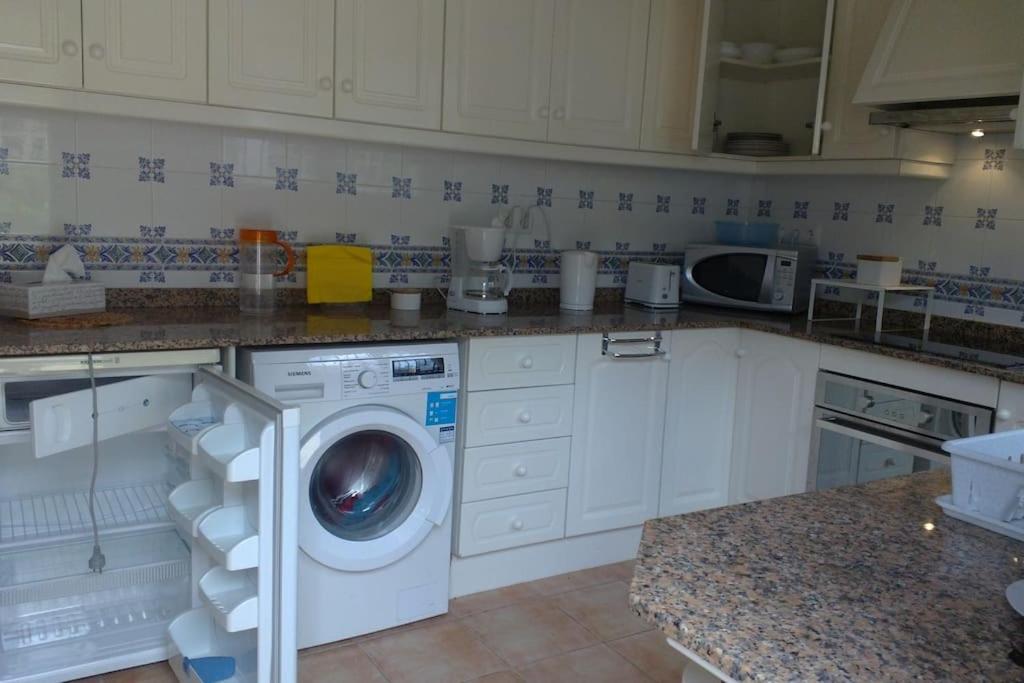 a kitchen with a washing machine in a kitchen at Casa Olga. This is your holiday Rest with pleasure in Benissa