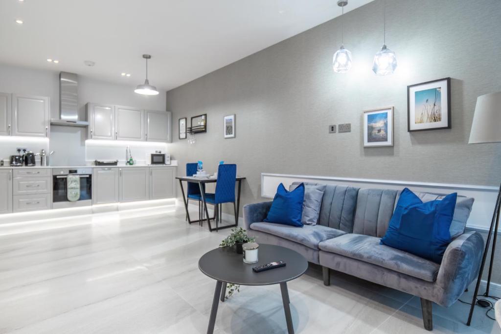 a living room with a couch and a table at LiveStay - Modern & Stylish Apartments in Oxfordshire in Didcot