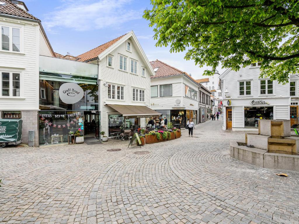 a cobblestone street in a town with many buildings at Charming Rooftop Apartment In Heart Of Stavanger in Stavanger