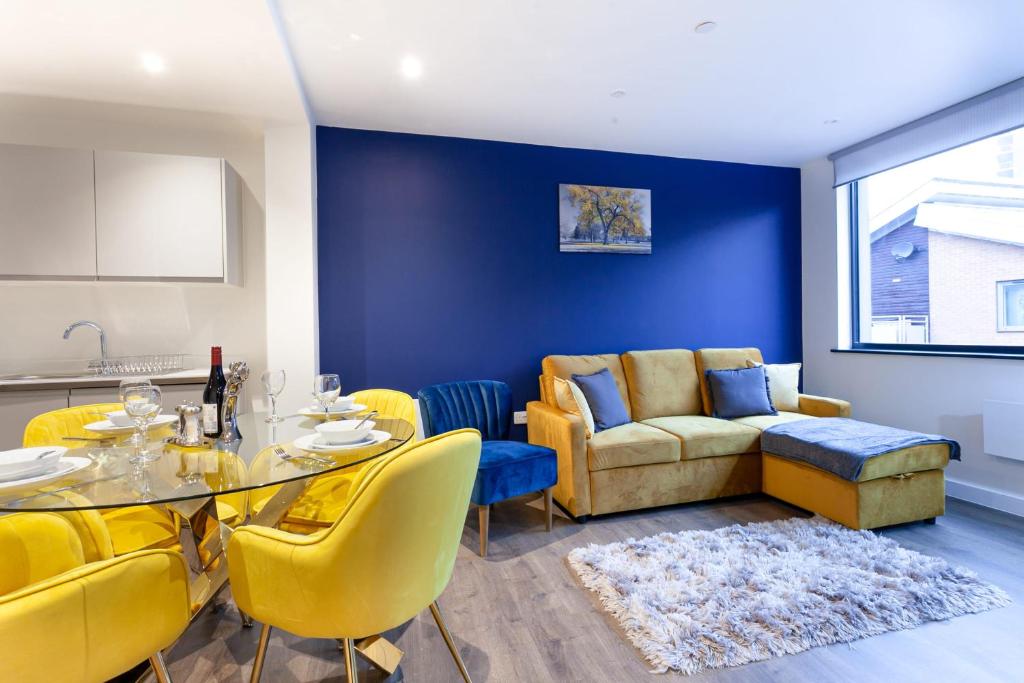 a living room with a table and yellow chairs at Contemporary 1 Bedroom Apartment in Manchester City Centre in Manchester