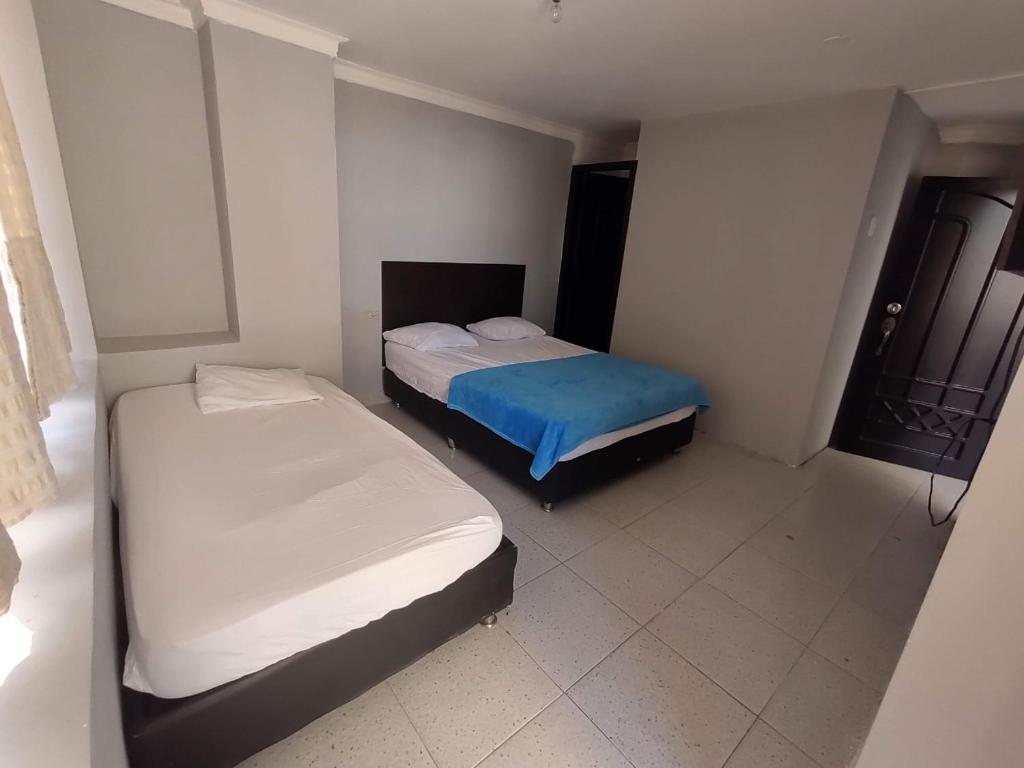 two beds in a small room with at Comfort inn in Maicao