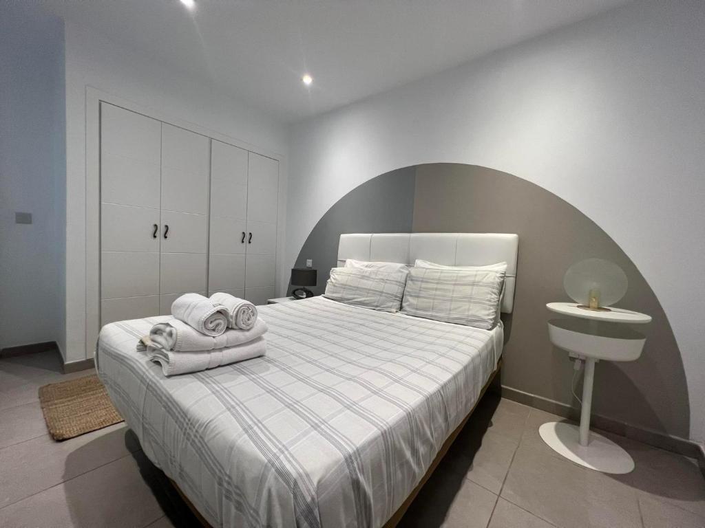 a bedroom with a large bed with towels on it at Eclectic 2BR with shared terrace perfect getaway in Gibraltar