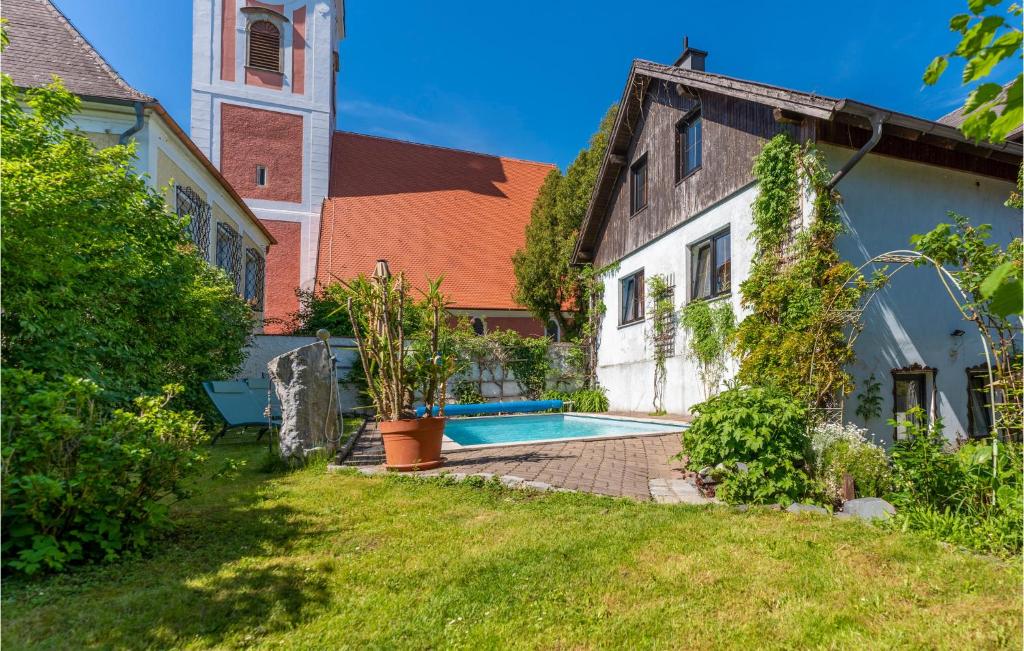 a courtyard of a building with a pool and a church at 1 Bedroom Nice Apartment In Gottsdorf in Gottsdorf
