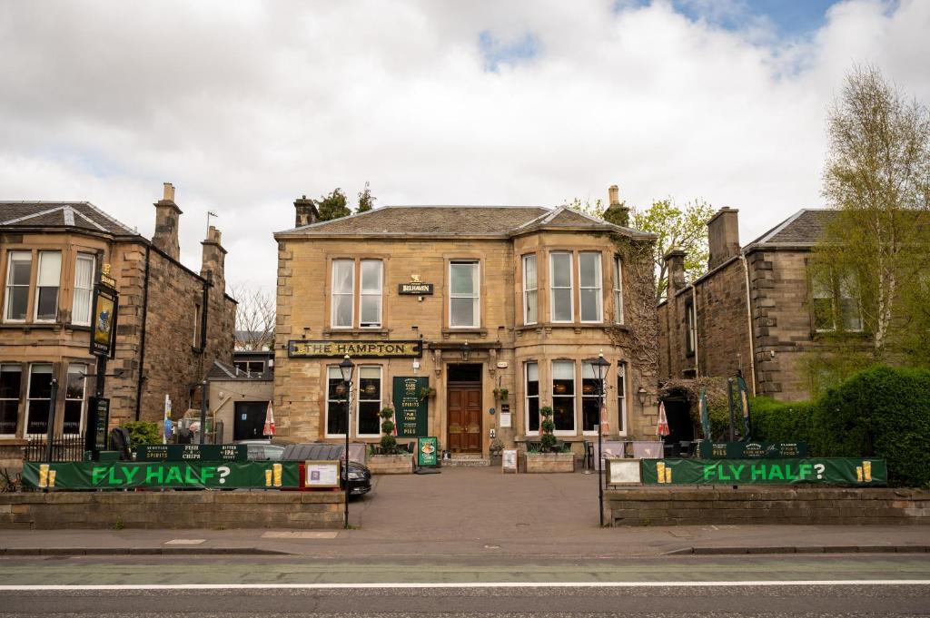 a large brick building with a gate in front of it at Hampton Hotel by Greene King Inns in Edinburgh