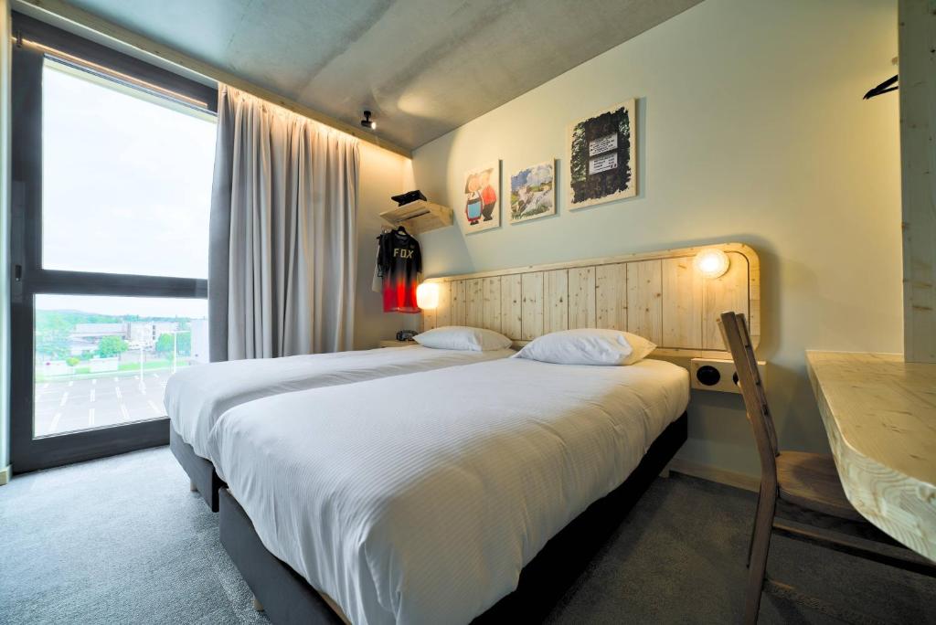 Postel nebo postele na pokoji v ubytování greet hotel Cernay Mulhouse