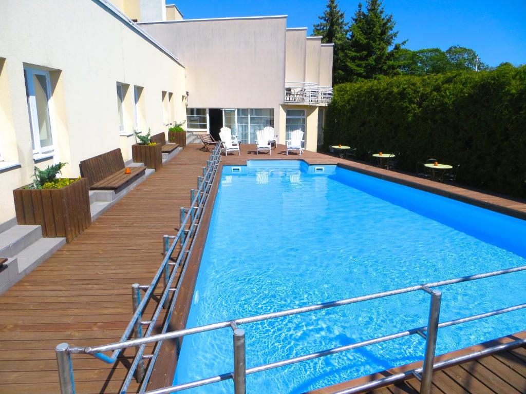 a large swimming pool on a balcony of a house at Hotel Vesiroos in Pärnu